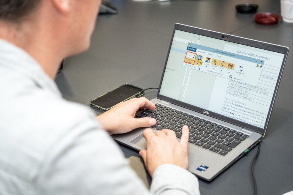 Employee working with magnification software on a laptop.